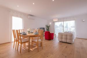 a living room with a table and chairs and a couch at Villa au coeur de Mézériat in Mézériat