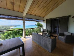 a living room with a couch and a view of the ocean at Villa Ti Kabri, 500 m de la plage, Ile Rodrigues, Ile Maurice in Saint Francois