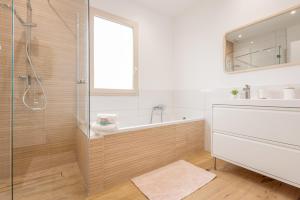 a bathroom with a tub and a sink and a shower at Villa au coeur de Mézériat in Mézériat +46 photos