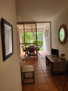 a living room with a table and a dining room at studio colibri in Saint-François +5 photos