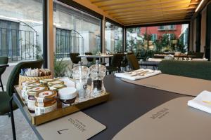 a table in a restaurant with a tray of food at MÍMESIS 11 - Boutique Hotel in Como