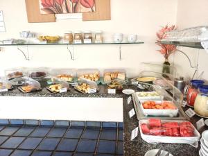a buffet with many food items on a counter at San Fernando Hotel in São Luís