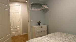 a bedroom with a bed and a dresser and a closet at Sjelefred - Ocean Suite in Sortland