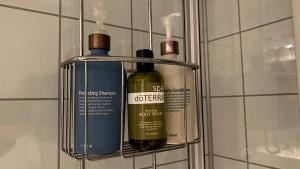 two bottles of wine are hanging on a wall at Sjelefred - Ocean Suite in Sortland +66 photos