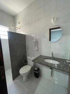 a bathroom with a toilet and a sink and a mirror at San Fernando Hotel in São Luís +21 photos