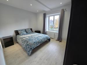 a bedroom with a bed and a window at Appartement proche Walibi in Les Avenières
