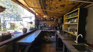 a kitchen with a long counter and a sink at Kosmik House in Punta Del Diablo