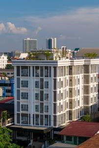 a white building with a city in the background at S 2 Modern Boutique Hotel in Vientiane
