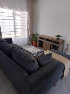 a large blue couch in a living room at T & M Apartments in Ndola