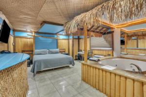 a bedroom with a bed and a tub in a room at Bentley Motel in Linden