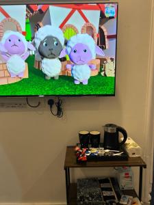 a flat screen tv with three cats on the wall at شقه مفروشه المدينة المنورة in Al Madinah