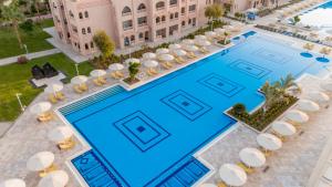 an overhead view of a large swimming pool with tables and chairs at Pickalbatros Aqua Vista Resort - Hurghada in Hurghada +144 photos