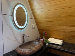 a bathroom with a large bowl sink on a counter at Lux Lake View Aframe - Skyframe in Kodaikānāl