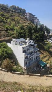 a building on the side of a hill at Shanti Residency Ramgarh in Rāmgarh