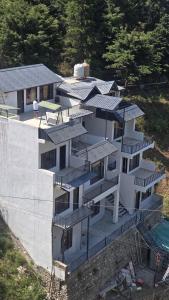 an aerial view of a building with solar panels on it at Shanti Residency Ramgarh in Rāmgarh