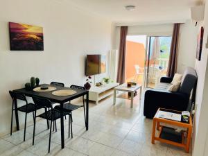 a living room with a table and chairs and a couch at Cielo Dorado in Santiago del Teide