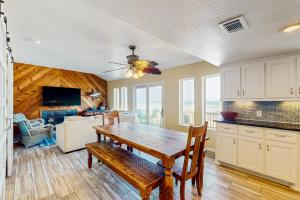 a kitchen and dining room with a table and a couch at Colony Make A Splash in Padre Island