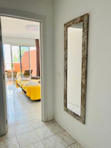 a mirror on a wall in a room with a bed at Cielo Dorado in Santiago del Teide +7 photos