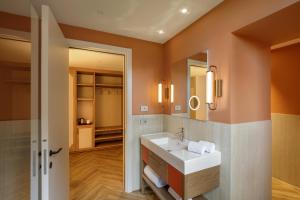 a bathroom with a sink and a mirror at Rosetta Hotel Perugia Tapestry Collection By Hilton in Perugia +77 photos
