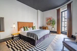 a hotel room with a bed and a couch at Crescent Place by Mansley in Cheltenham