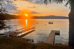 a dock on a lake at sunset with a boat at Four Seasons Lakehouse in Franklin