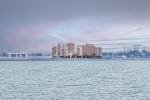 a building on the shore of a body of water at Corp Yanbu Hotel in Yanbu