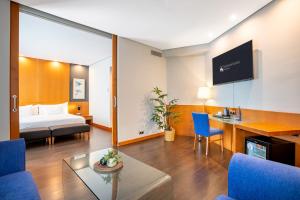 a hotel room with a bed and a table and chairs at Eurostars Atlántida in Santa Cruz de Tenerife