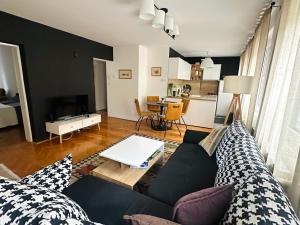 a living room with a couch and a table at Layla's Home Free Parking in Sarajevo