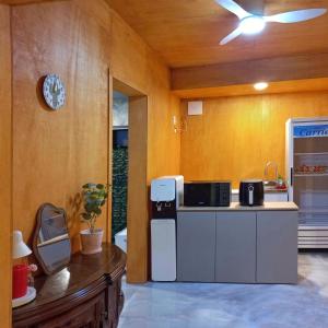 a kitchen with a refrigerator and a microwave at 에어진주 AirJINJU in Jinju