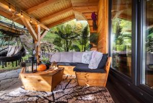 - une terrasse couverte avec un canapé et une table dans l'établissement Chata na Skarpie - SPA i widok na Skrzyczne, à Szczyrk