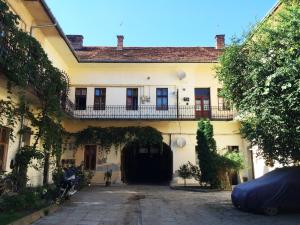 a large white building with a gate and a courtyard at Contessa Apartment Cluj Napoca in Cluj-Napoca