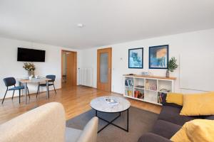 a living room with a couch and a table at Bodensee Bungalow in Immenstaad am Bodensee