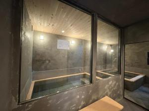 a bathroom with a shower with a glass window at 箱根強羅 縁 in Hakone