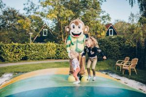 a little girl and a girl in a mickey mouse costume at Vakantiepark 't Hooge Holt in Gramsbergen +9 photos