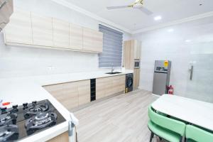 a kitchen with a stove and a counter top at Luxurious townhouse behind Achimota Mall in Accra