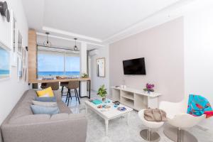 a living room with a couch and a table at Azur in Bin Rhilouf