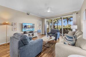 a living room with two couches and a flat screen tv at Relaxed Golfside Living with New Furnishings & Scenic Views - Palm Breeze Fairway in Gateway