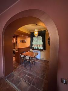 an archway in a kitchen with a table and chairs at Pansion M in Požarevac +11 photos