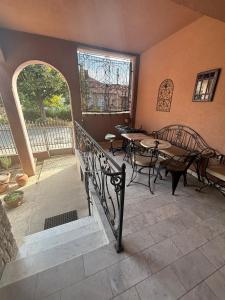 a patio with tables and chairs and a window at Pansion M in Požarevac