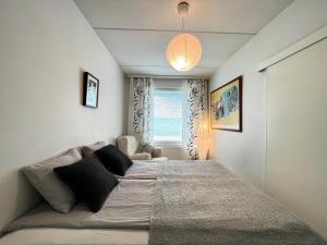 a bedroom with a large bed and a window at Cozy flat in Suurpelto in Espoo