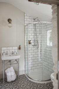 a bathroom with a shower and a sink at Ty Bach in Llanwrtyd Wells