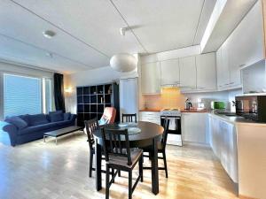 a kitchen and living room with a table and chairs at Cozy flat in Suurpelto in Espoo +6 photos