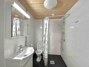 a bathroom with a sink and a toilet and a mirror at Cozy flat in Suurpelto in Espoo