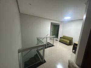 a room with a staircase and a bed in it at Casa Confortável in Belém