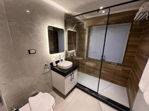 a bathroom with a toilet and a sink and a shower at SWAN DAHABIYA Luxury Boutique Nile Cruise - Every Friday from Aswan for 3 nights & Every Monday from Luxor for 4 nights in Luxor