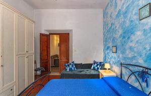 a blue bedroom with a bed and a couch at Eco B&B I Due Oleandri in Marina di Carrara