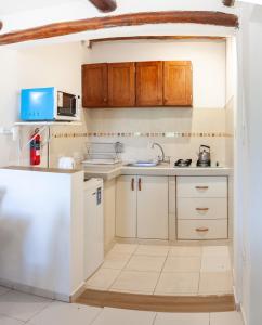 a kitchen with white cabinets and a sink at Cabañas Mi Cata Hermosa - Catamarca Capital in San Fernando del Valle de Catamarca