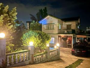a house with a fence and a car parked in front at A Borneo Homestay in Johor Bahru