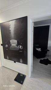 a flat screen tv on a wall with a car on it at Luxury Apartments Black Diamond in Ši Selo