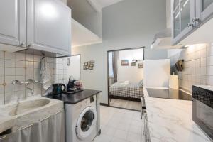a kitchen with a sink and a washing machine at Cuore di Genova in Genova